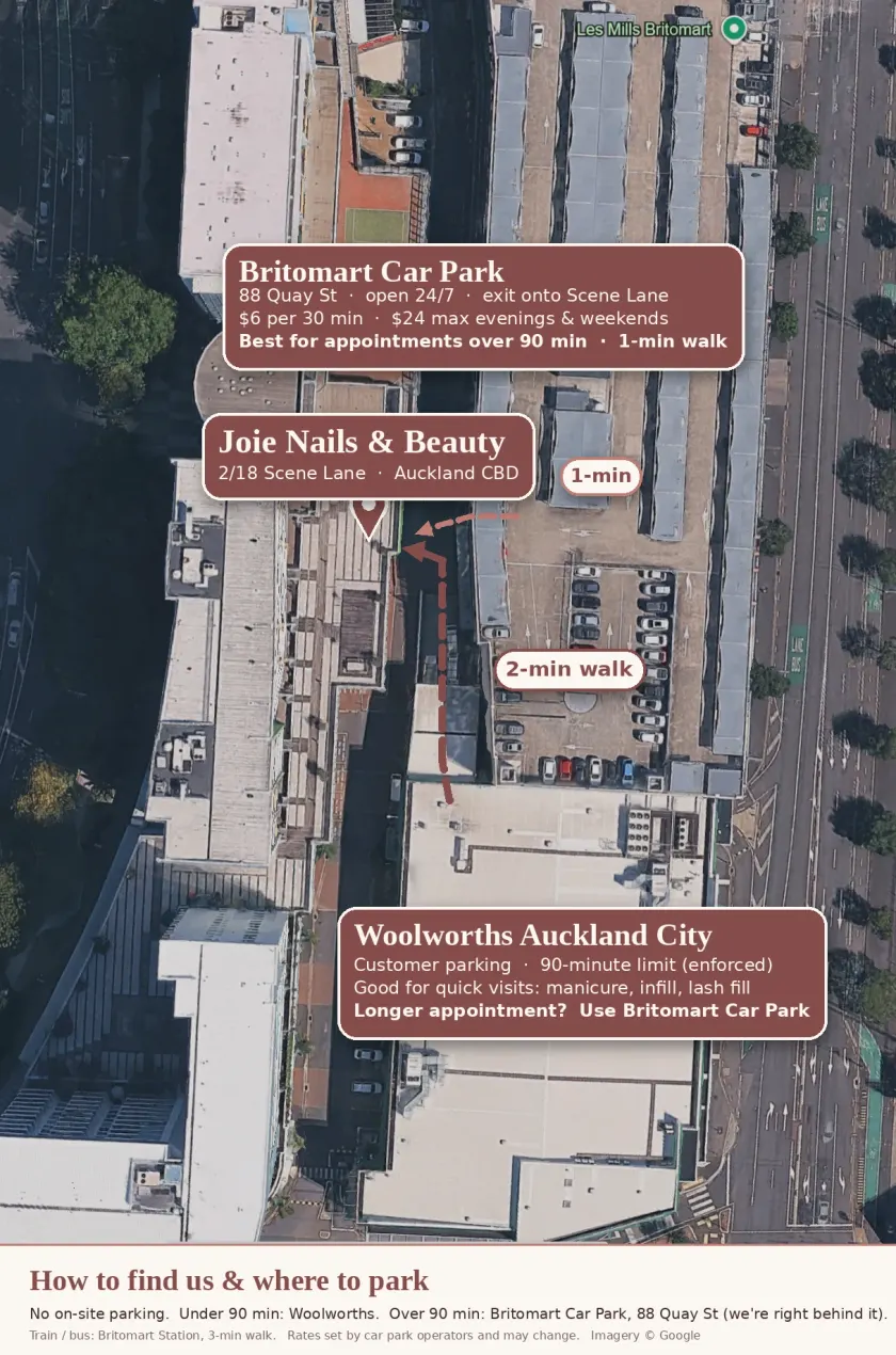 Satellite map showing Joie Nails & Beauty on Scene Lane, Britomart Car Park beside it and Woolworths Auckland City a two-minute walk away