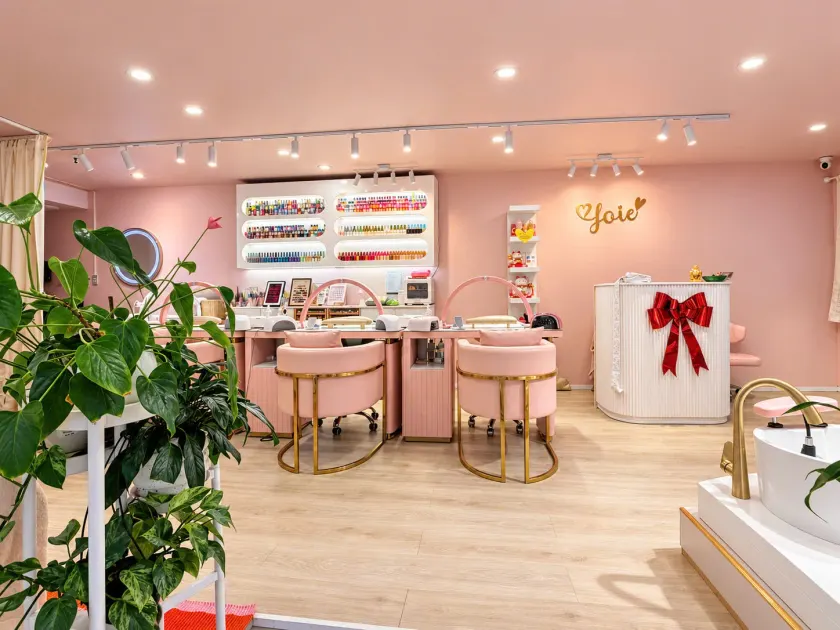 The pink reception and manicure stations at Joie Nails & Beauty